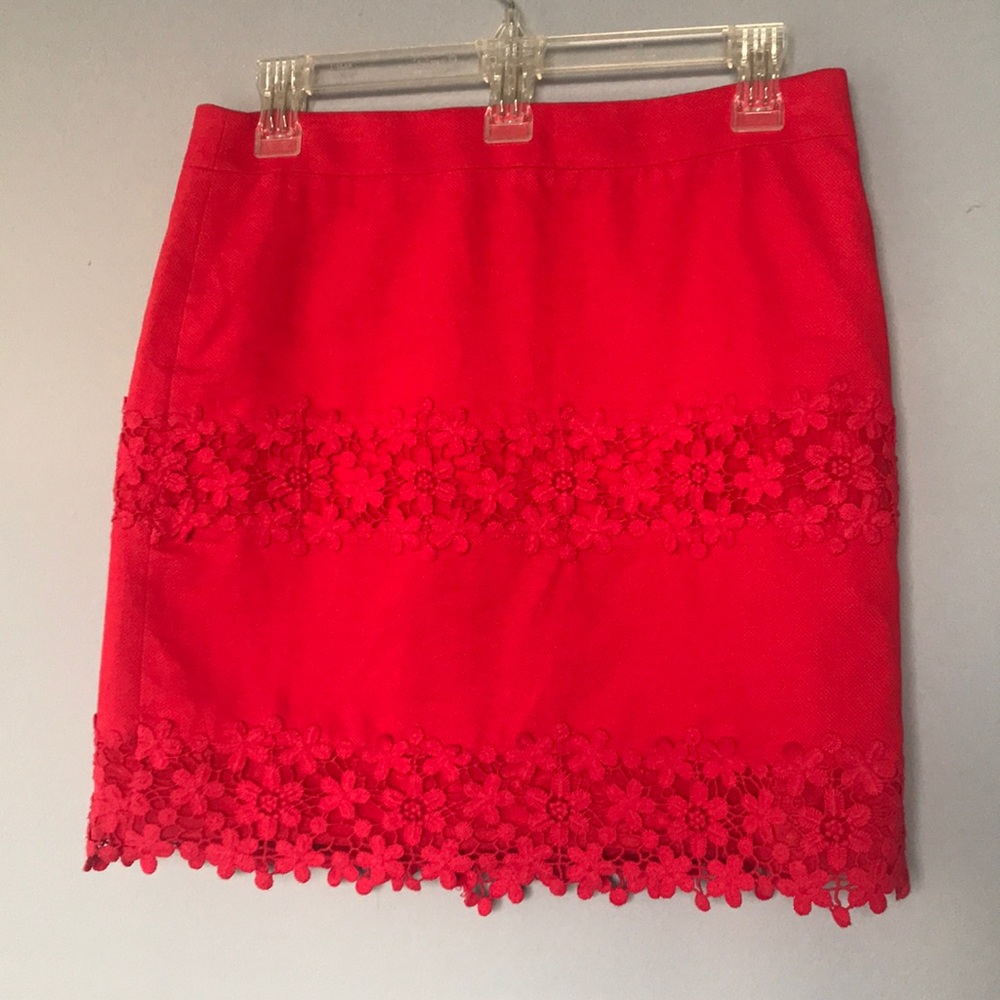 Deep coral colored skirt with embroidered trim